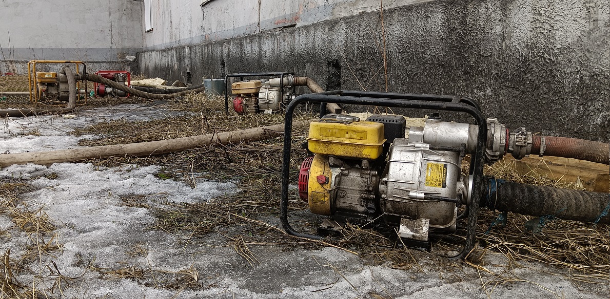 Откачка мотопомпами талой воды из подвала дома в Боброве